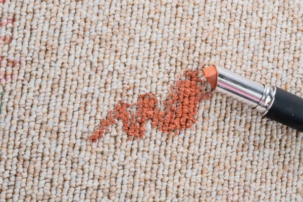 Dirty stain of lipstick on the carpet or sofa. daily life stain concept. top view. High quality photo