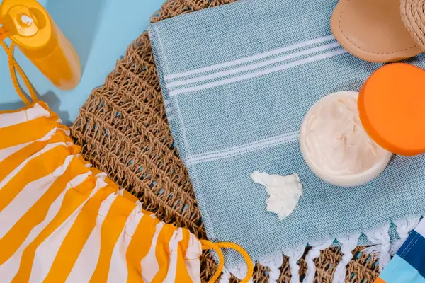 Dirty stain of spilled sunscreen on clothes on a blue background. Daily life dirty stain concept. flat lay. High quality photo