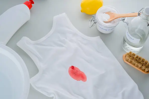 Dirty blood stains or wine on clothes. The concept of organic removing stains on clothes with baking soda. Zero waste concept. top view. High quality photo