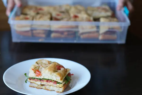 stock image Italian healthy breakfast focaccia. Flatbread with filling arugula, cheese, tomatoes in a plate. side view. Healthy sourdough bread. High quality photo