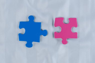 Yumuşak bir çarşaf üzerinde mavi ve pembe renkli yapboz parçaları. İlişki ve sağlık kavramı. Üst Manzara. Yüksek kalite fotoğraf