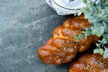 Freshly baked challah bread resting on a concrete background. Jewish holiday. space for text. . High quality photo clipart