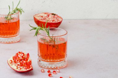 A festive drink made of pomegranate juice and rosemary. Holiday cocktail for Thanksgiving, Christmas or New Year's Eve. High quality photo clipart