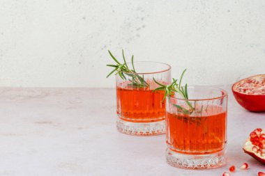 A festive drink made of pomegranate juice and rosemary. Holiday cocktail for Thanksgiving, Christmas or New Year's Eve. High quality photo clipart