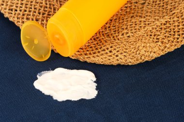 Spilled sunscreen from a yellow tube on clothes or towel. A dirty cosmetic stain on the fabric. The concept of daily stains on clothes. High quality photo clipart