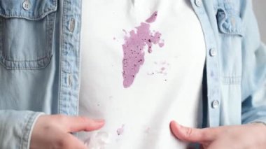 Beyaz gömleklerine mor dondurma döküldü. Rahatlamış atmosfer bir anlık eğlenceyi işaret ediyor. Giysilerdeki günlük lekeler