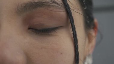 Kar yağarken Asyalı kadınların gözü, yakın plan.