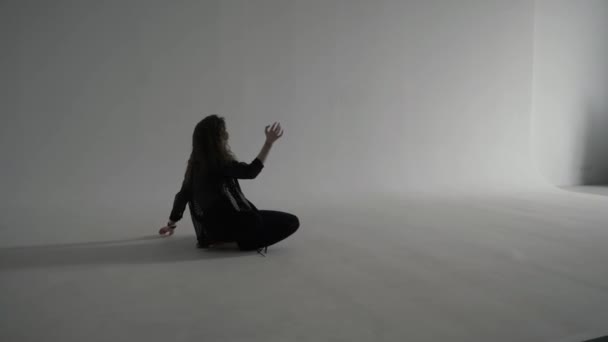 Curly Beautiful Woman Black Clothes Dances Floor Cyclorama White Photo — Stock Video