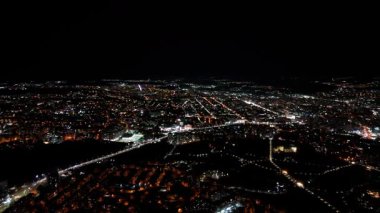 Chisinau 'da parlayan şehir ışıklarının ve işlek sokakların insansız hava aracı görüntüsü