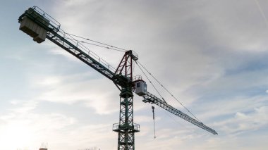 Bulutlu gökyüzüne karşı inşaat alanında kule vinci