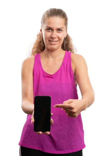 Friendly Adult Woman Pink Sportswear Smiling Pointing Index Finger Smartphone — Stock Fotó