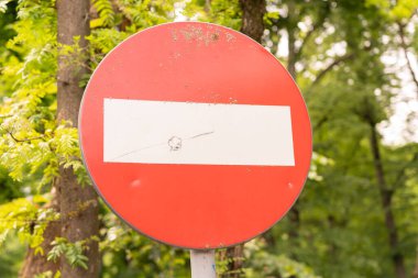 Traffic sign as forbidden stop concept on forest road park with green trees as urban outdoor nature summer or fall autumn