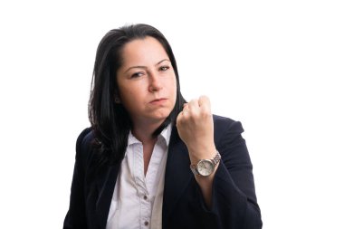 Angry mad female entrepreneur businesswoman wearing smart casual clothing showing fist as angry gesture and expression isolated on white background