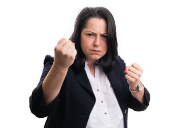 Angry businesswoman wearing casual formal suit showing fists as aggressive fighting gesture and expression corporate concept isolated on white background