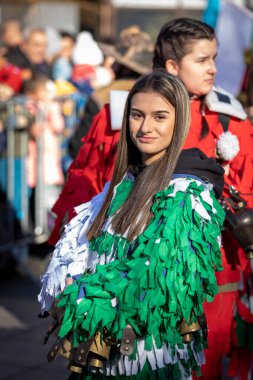 Sofia, Bulgaria - January 08, 2023: Unidentified woman in traditional kuker costume at the Surva masquerade games festival in Sofia, Bulgaria. Kuker costume at the masquerade games in Sofia, Bulgaria