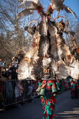 Sofia, Bulgaria - January 08, 2023: Unidentified man in traditional kuker costume at the Surva masquerade games festival in Sofia, Bulgaria. Kuker costume at the masquerade games in Sofia, Bulgaria