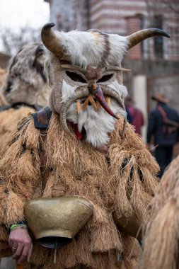 Breznik, Bulgaria - January 21, 2023: Masquerade festival in Breznik Bulgaria. People with a mask called Kukeri dance and perform to scare the evil spirits. The photo was taken on January 21th, 2023