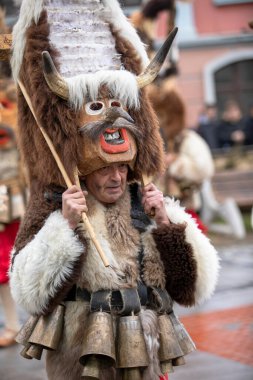 Breznik, Bulgaria - January 21, 2023: Masquerade festival in Breznik Bulgaria. People with a mask called Kukeri dance and perform to scare the evil spirits. The photo was taken on January 21th, 2023