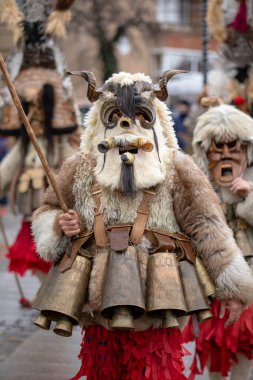 Breznik, Bulgaria - January 21, 2023: Masquerade festival in Breznik Bulgaria. People with a mask called Kukeri dance and perform to scare the evil spirits. The photo was taken on January 21th, 2023