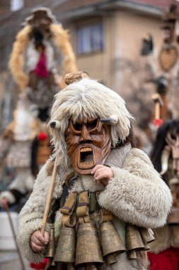 Breznik, Bulgaria - January 21, 2023: Masquerade festival in Breznik Bulgaria. People with a mask called Kukeri dance and perform to scare the evil spirits. The photo was taken on January 21th, 2023