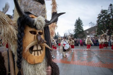Breznik, Bulgaria - January 21, 2023: Masquerade festival in Breznik Bulgaria. People with a mask called Kukeri dance and perform to scare the evil spirits. The photo was taken on January 21th, 2023