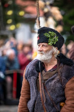 Breznik, Bulgaria - January 21, 2023: Masquerade festival in Breznik Bulgaria. People with a mask called Kukeri dance and perform to scare the evil spirits. The photo was taken on January 21th, 2023