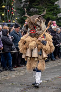 Breznik, Bulgaria - January 21, 2023: Masquerade festival in Breznik Bulgaria. People with a mask called Kukeri dance and perform to scare the evil spirits. The photo was taken on January 21th, 2023