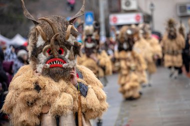 Breznik, Bulgaria - January 21, 2023: Masquerade festival in Breznik Bulgaria. People with a mask called Kukeri dance and perform to scare the evil spirits. The photo was taken on January 21th, 2023