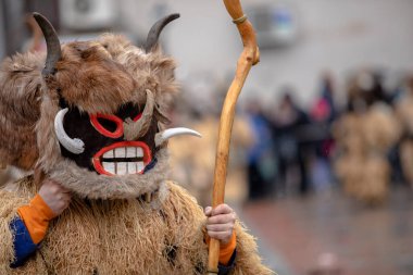 Breznik, Bulgaria - January 21, 2023: Masquerade festival in Breznik Bulgaria. People with a mask called Kukeri dance and perform to scare the evil spirits. The photo was taken on January 21th, 2023