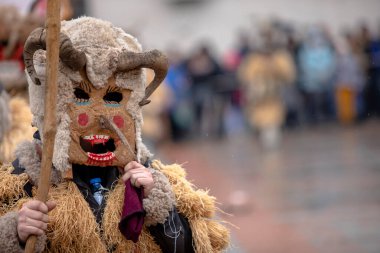 Breznik, Bulgaria - January 21, 2023: Masquerade festival in Breznik Bulgaria. People with a mask called Kukeri dance and perform to scare the evil spirits. The photo was taken on January 21th, 2023