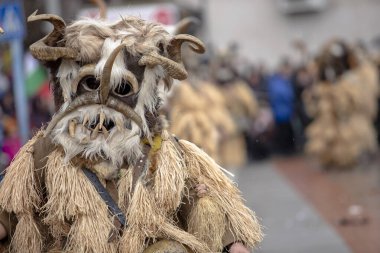 Breznik, Bulgaria - January 21, 2023: Masquerade festival in Breznik Bulgaria. People with a mask called Kukeri dance and perform to scare the evil spirits. The photo was taken on January 21th, 2023
