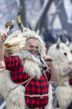 Pernik, Bulgaria - January 28, 2023: Masquerade festival in Pernik Bulgaria. People with a mask called Kukeri dance and perform to scare the evil spirits. The photo was taken on January 28th, 2023