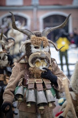 Breznik, Bulgaristan - 20 Ocak 2024: Bulgaristan 'ın Breznik kentinde maskeli balo festivali. Kukeri adındaki maskeli insanlar kötü ruhları korkutmak için dans edip gösteri yapıyorlar. Fotoğraf 20 Ocak 2024 'te çekildi.