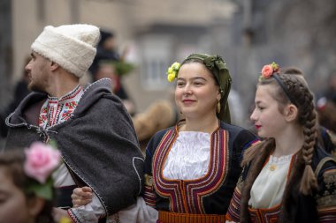 Bulgaristan 'ın Kyustendil kenti - 10 Şubat 2024: Bulgaristan' ın Kyustendil kentinde düzenlenen maskeli balo festivalinin birincisi. Bulgar halk dansları giyinmiş kadınlar doğurganlık ve sağlık ayini düzenliyor..