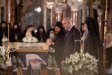 Sofia, Bulgaria, 16 March, 2024: The President of the Republic of Bulgaria Rumen Radev pays tribute to Patriarch Neophyte. clipart