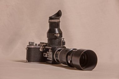 A vintage pre-SLR film camera with a telephoto lens. The eyepiece on the lens is required for focusing clipart