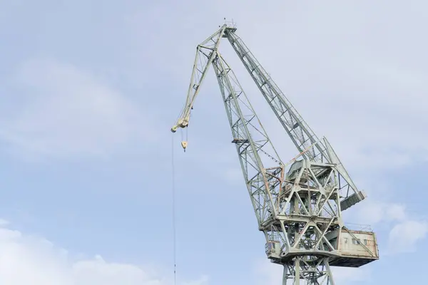 stock image port crane against the blue sky, close-up. Industrial background