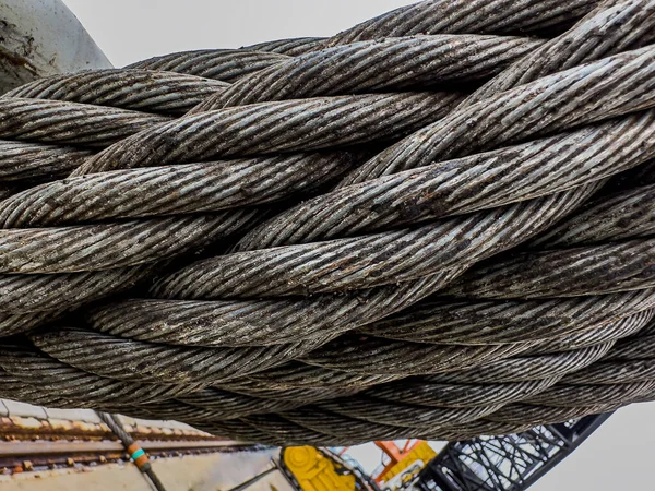 The steel metal cable closed up. Industrial twisted metal tow cable for heavy vehicles or machinery.