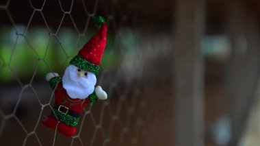 Noel Baba Noel 'e tırmanıyor. Arka planda kuşlar ötüyor. Noel ve Yeni Yıl konsepti. 11-30-2024
