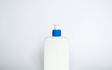 White unbranded plastic dispenser pump bottle on white background. Cosmetic package mockup, liquid soap flacon, hand sanitizer without label, shampoo organic spa, shower gel