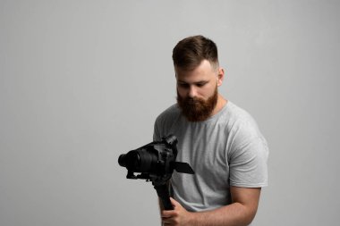 Professional filmmaker with a dslr camera on 3-axis gimbal stabilizer. Filmmaking, videography, hobby and creativity concept