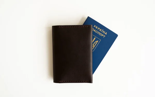 Ukrainian passport with a leather cover on a white background, selective focus. Inscription in Ukrainian Ukraine Passport
