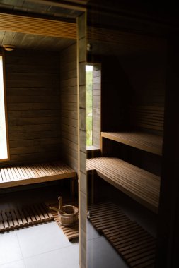 Finlandiya saunasının içi, sıcak buharlı klasik ahşap sauna. Büyük standart tasarım klasik ahşap sauna iç tasarımı.