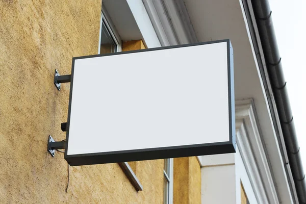 Street hanging mounted light box on the wall sign mockup template. Signboard mock up for logo presentation.