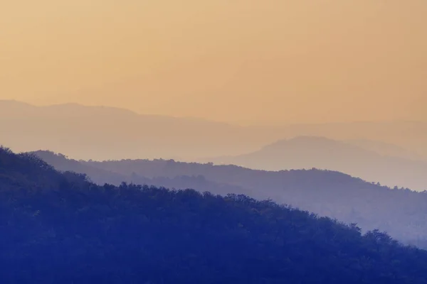 stock image Bluish colored hazy layers of hills at sunset. Landscapes, environment and climate concepts