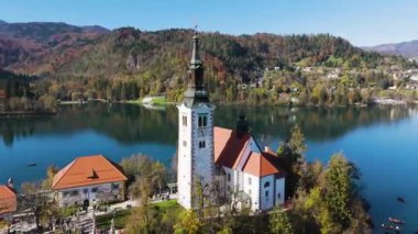 Slovenya 'daki Bled Gölü' ndeki adada Meryem 'in Varsayımına adanmış bir hac kilisesi, turistik bir yer ve dönüm noktası. Seyahat, turizm ve inanç kavramları. 4K, 60FPS