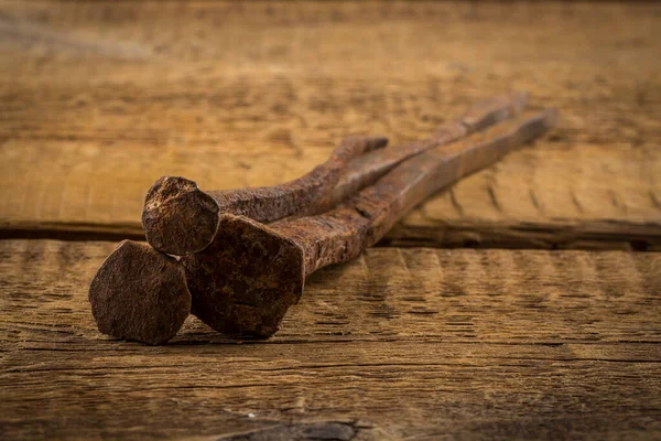 Vintage old hammer with rusty nails on wood table background