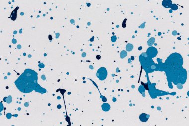 Blue drops paint texture background blue color on white paper. Brush stroke. Hand made