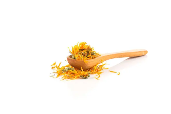 stock image Calendula flowewr tea for infusion in wooden spoon on white background