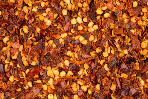 Hromadu Drcený Červený Pepř Sušené Chilli Vločky Semena Jako Pozadí — Stock fotografie